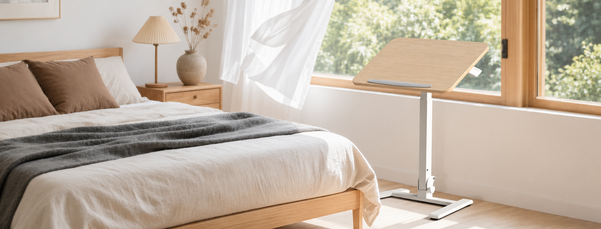 Mobile Folding Desk in Beige beside a bed, with the top tilted